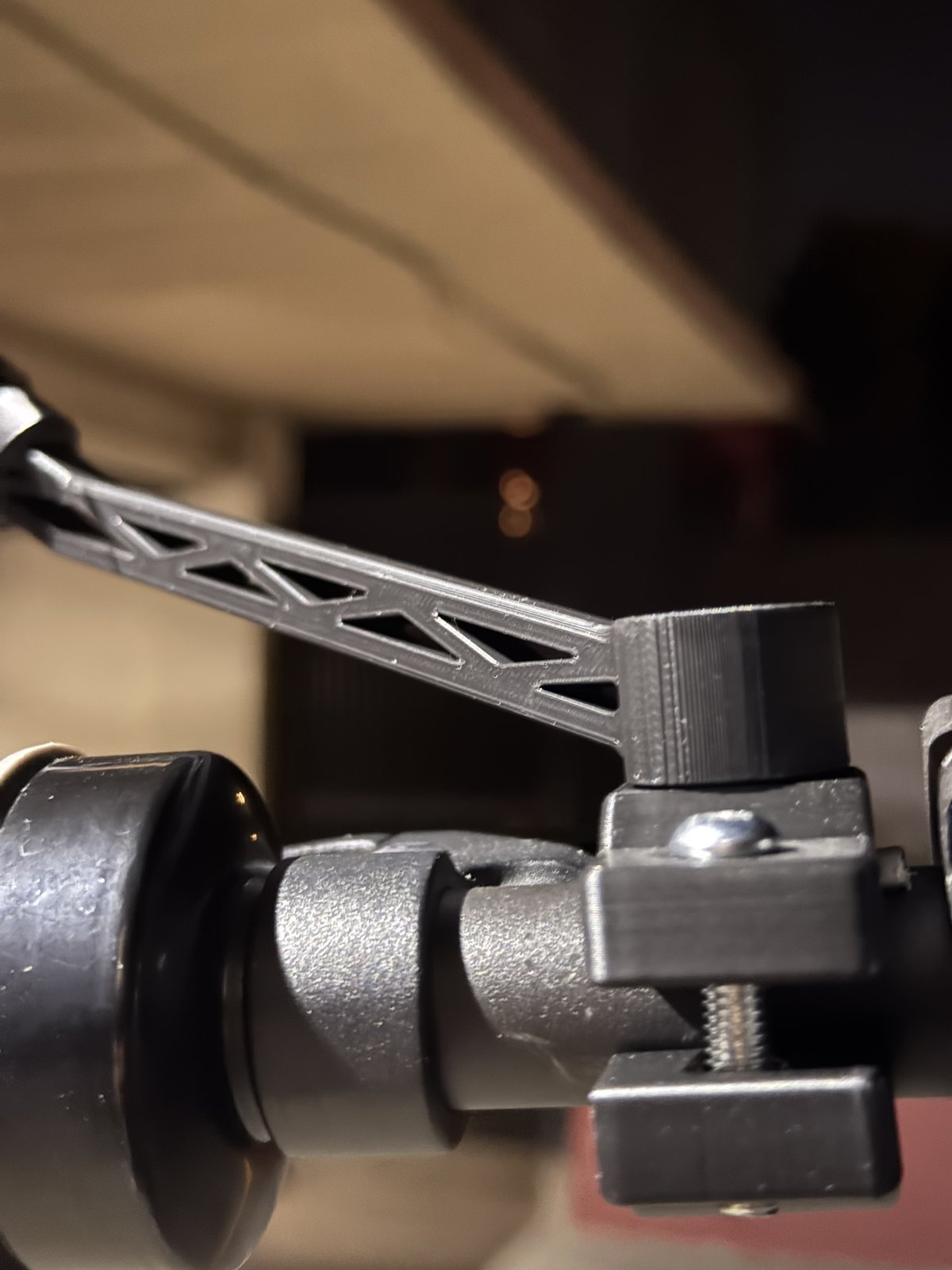 Trussed mirror arm mounted to the handlebar, photographed at night