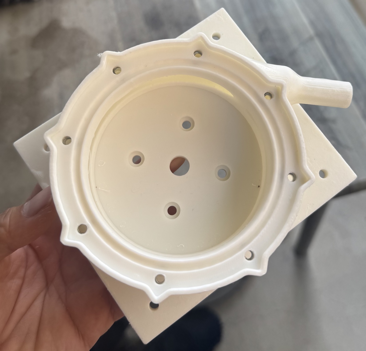An FDM printed volute half coated in Flex Seal to waterproof the porous print