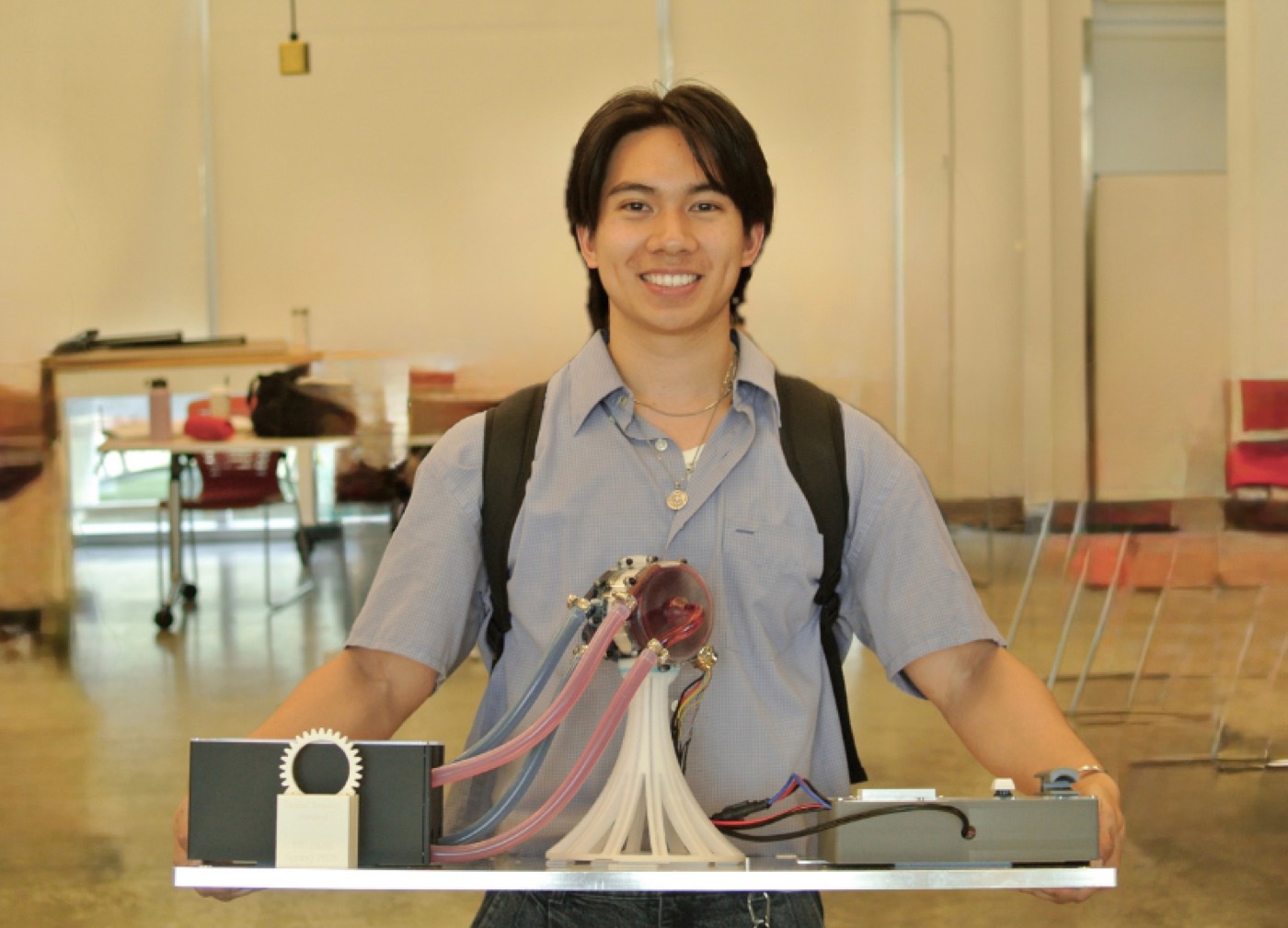 Reagan Bagnol holding the Total Artificial Heart he built for his senior capstone