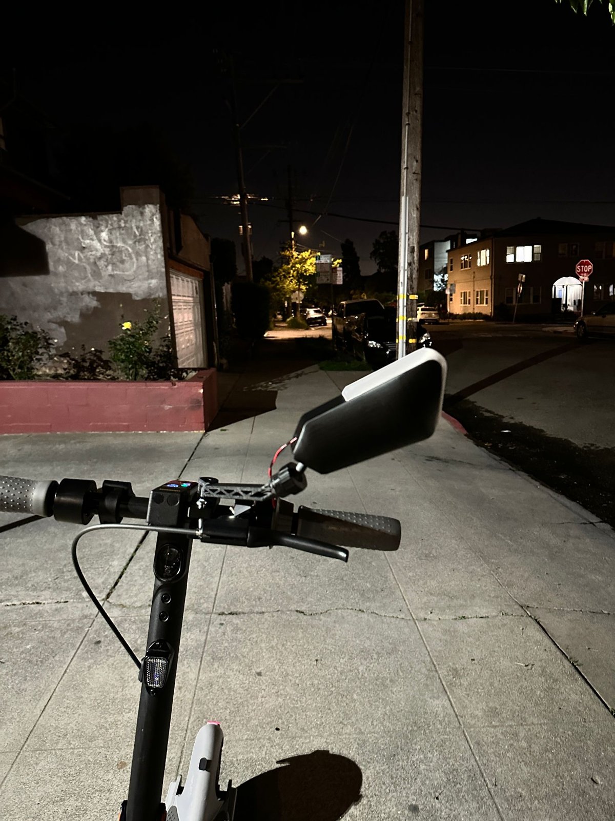 Functional prototype mounted on a scooter at night, mirror angled outward