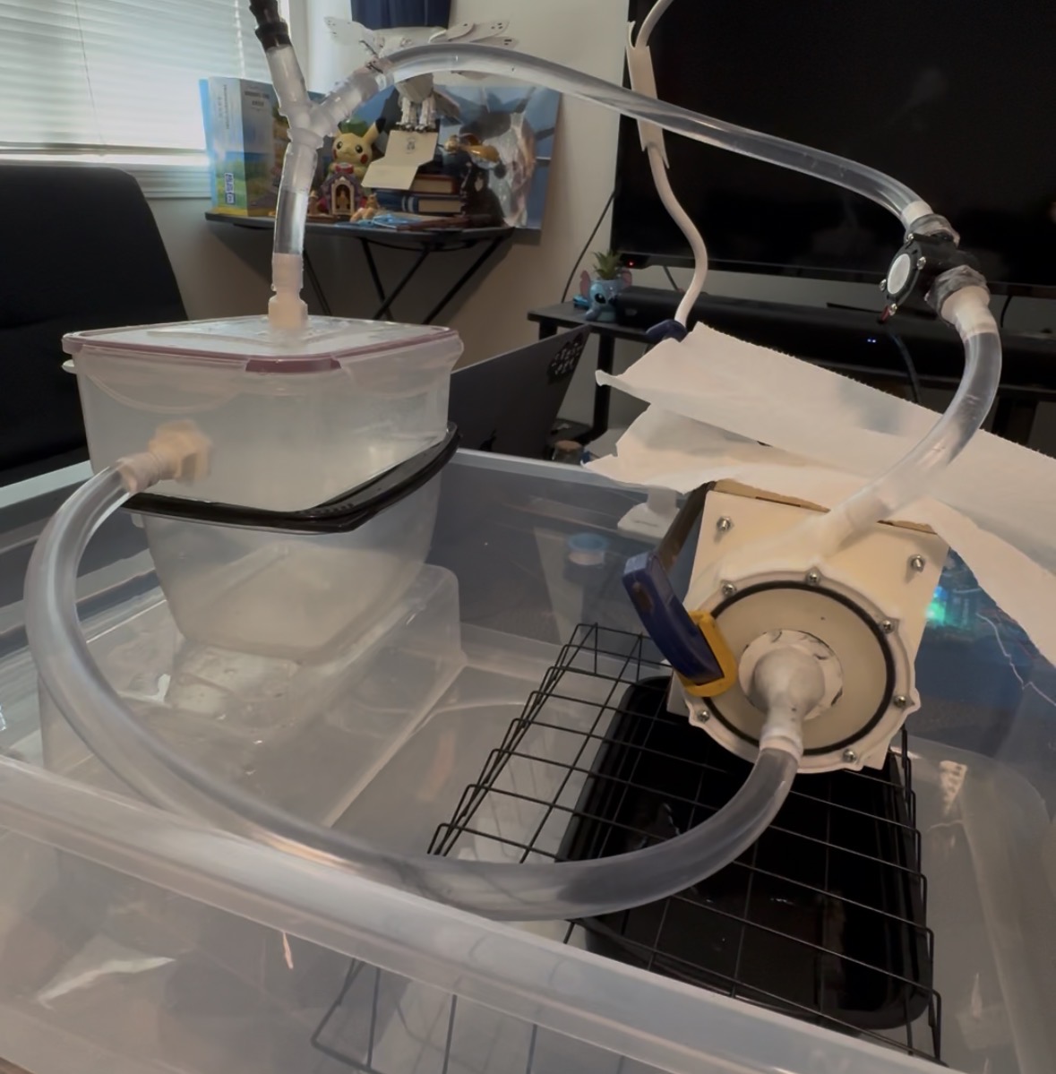 The assembled flow-rate test rig: reservoir, closed tubing loop, volute and impeller, and catch tray